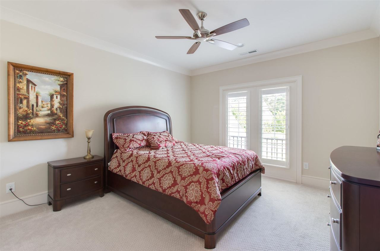 136 Turner Ridge Circle Durham, NC 27713 - Photo 20 of 30 a bedroom with a bed and a chandelier