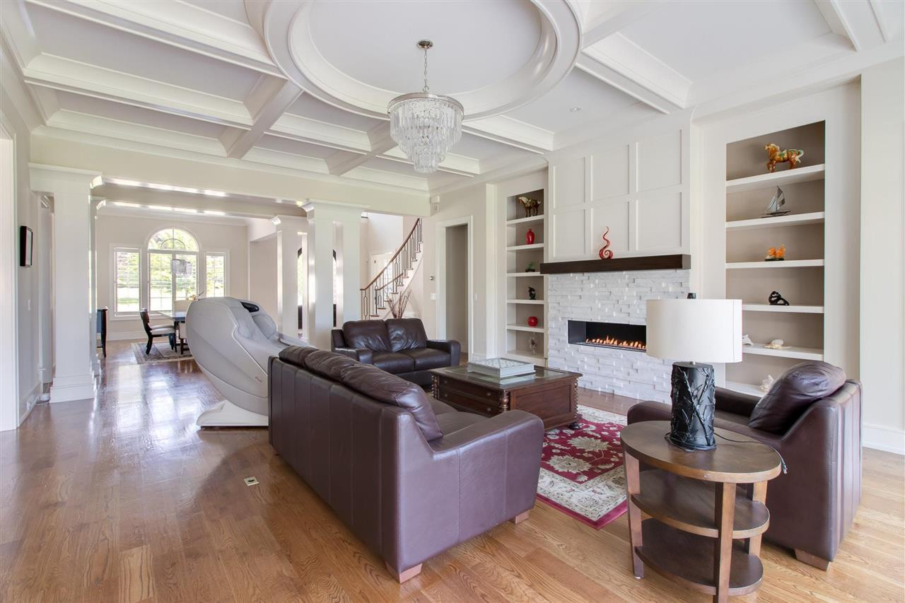 136 Turner Ridge Circle Durham, NC 27713 - Photo 6 of 30 a living room with furniture a fireplace and a chandelier