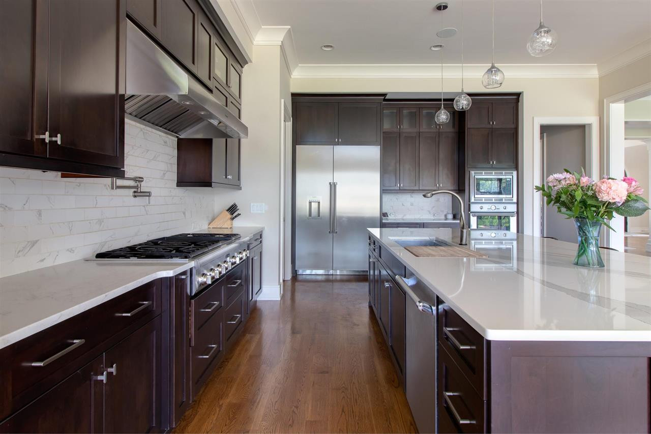 136 Turner Ridge Circle Durham, NC 27713 - Photo 9 of 30 a kitchen with stainless steel appliances granite countertop a sink a stove and a refrigerator