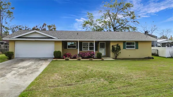 a view of a house with backyard and garden