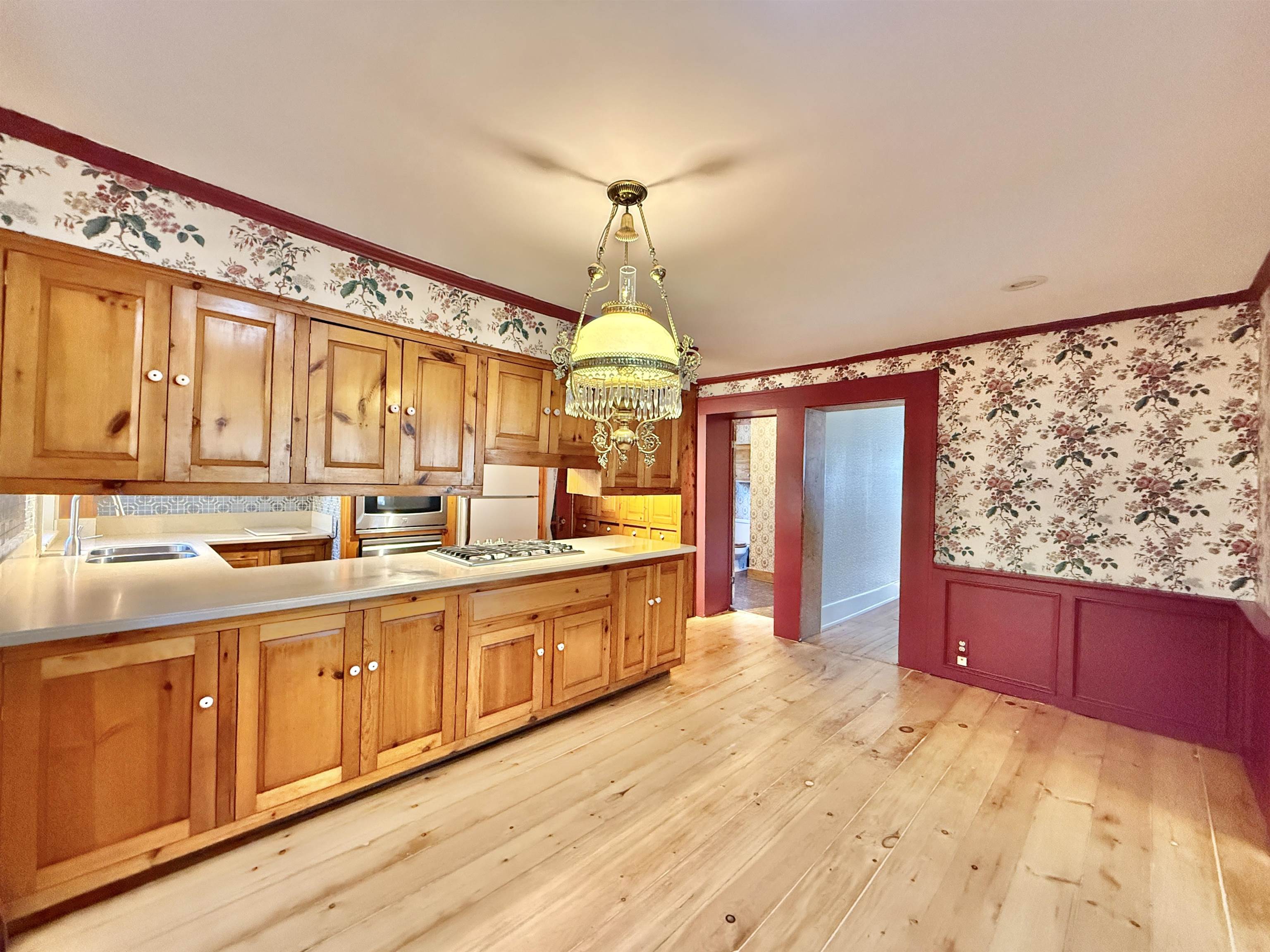 702 Washington Street Rockton, IL 61072 - Photo 11 of 29 a large kitchen with stainless steel appliances granite countertop a sink dishwasher a stove and white cabinets with wooden floor