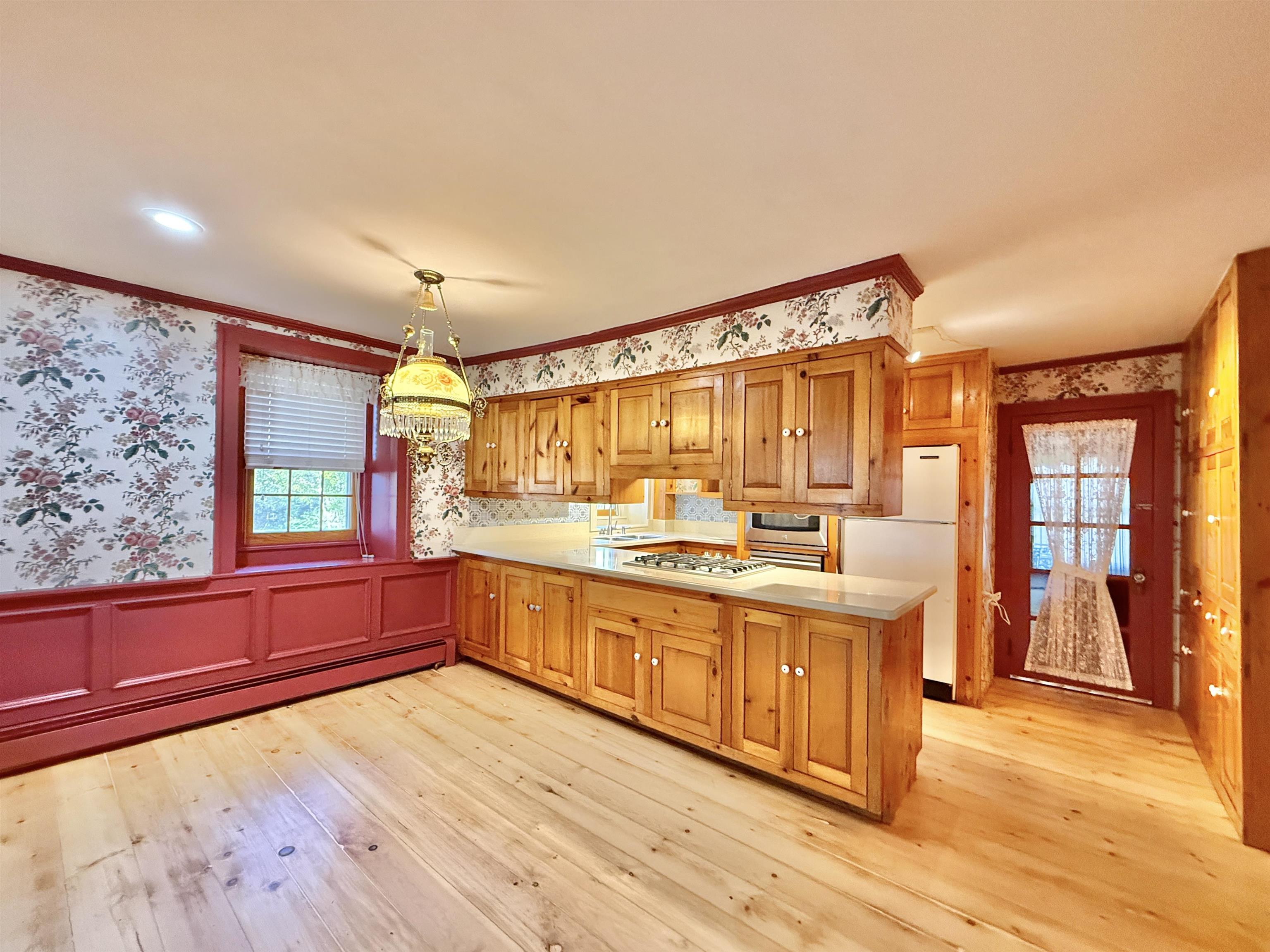 702 Washington Street Rockton, IL 61072 - Photo 15 of 29 a large kitchen with kitchen island granite countertop wooden floors and wide window