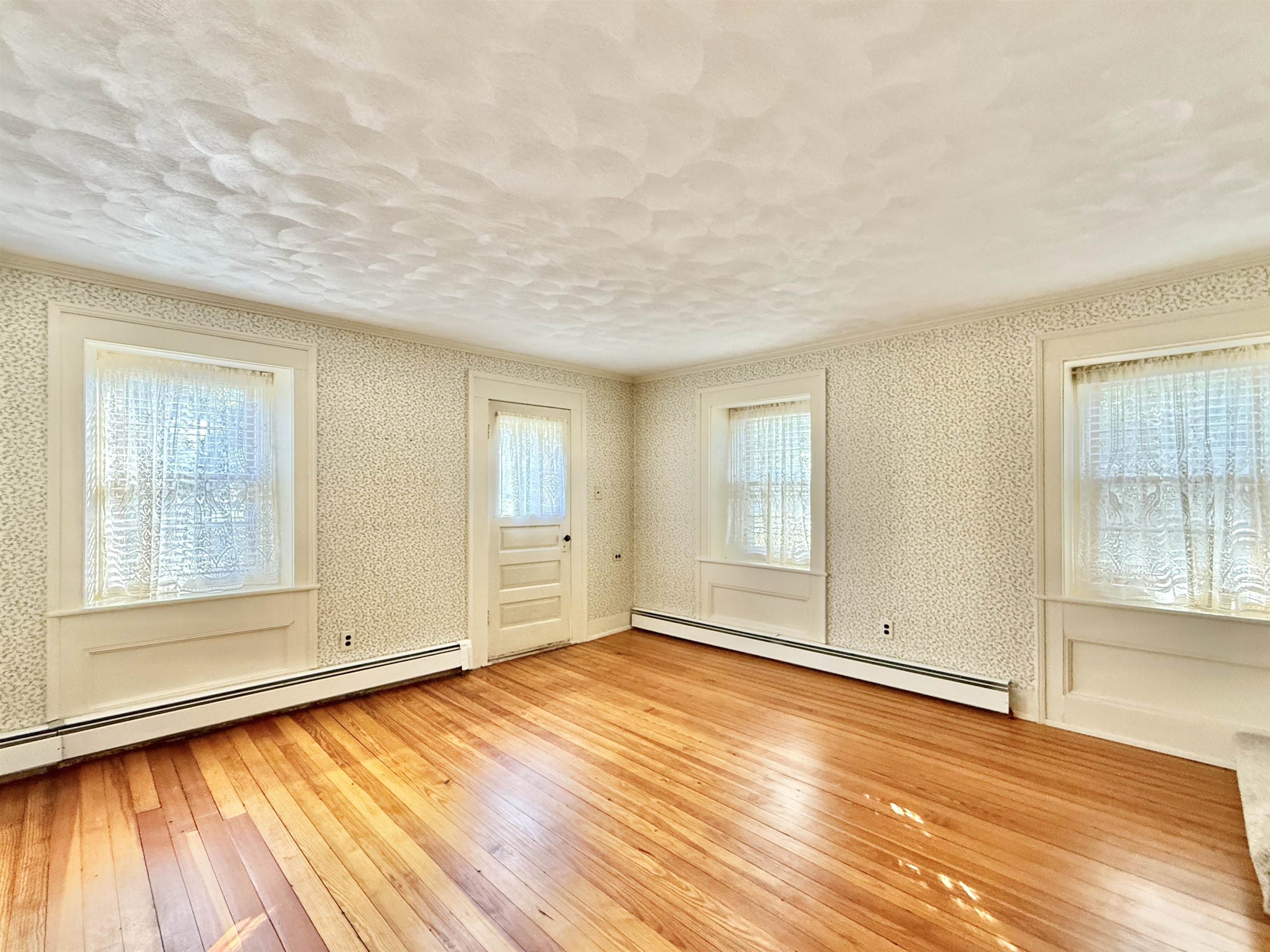 702 Washington Street Rockton, IL 61072 - Photo 3 of 29 an empty room with wooden floor and windows