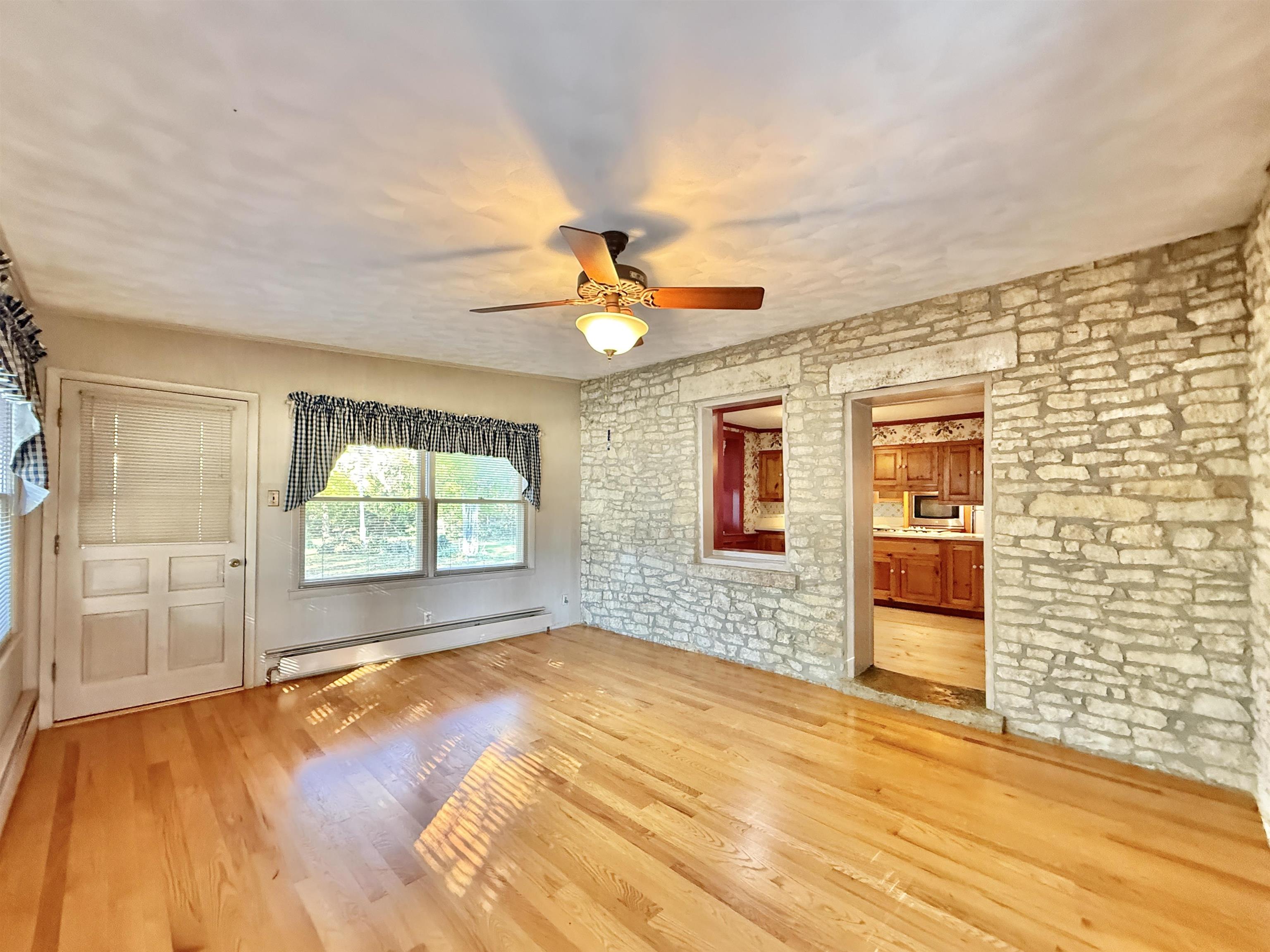 702 Washington Street Rockton, IL 61072 - Photo 9 of 29 a view of an empty room with a window and fireplace