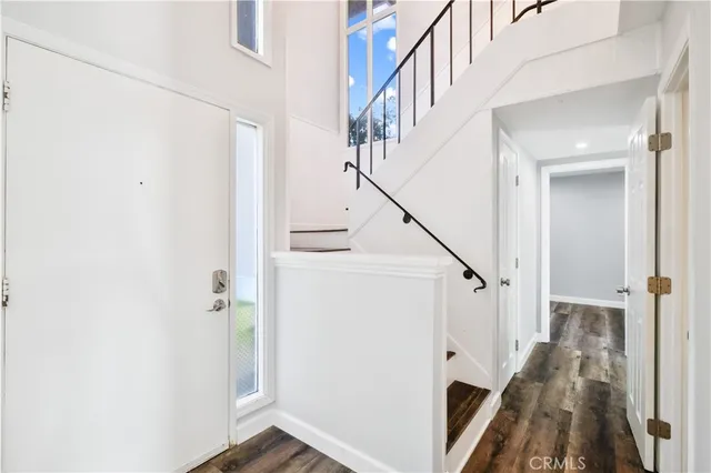 a view of a room with a large bed and wooden floor