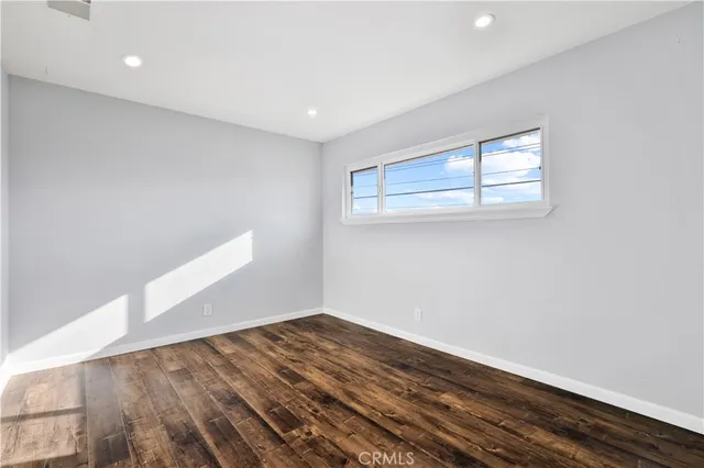a bathroom with a granite countertop sink a toilet and a mirror
