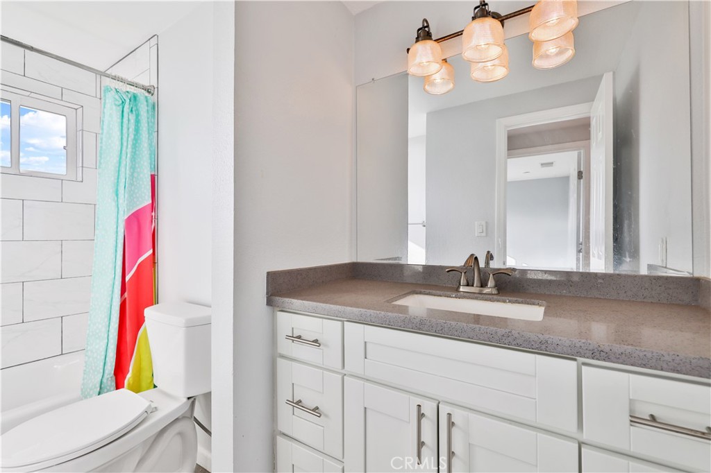 2702 College Lane La Verne, CA 91750 - Photo 22 of 53 a bathroom with a granite countertop sink a toilet and a mirror