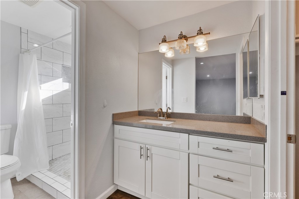 2702 College Lane La Verne, CA 91750 - Photo 27 of 53 a bathroom with a granite countertop sink and a mirror