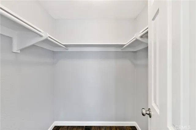 a view of an empty room and wooden floor