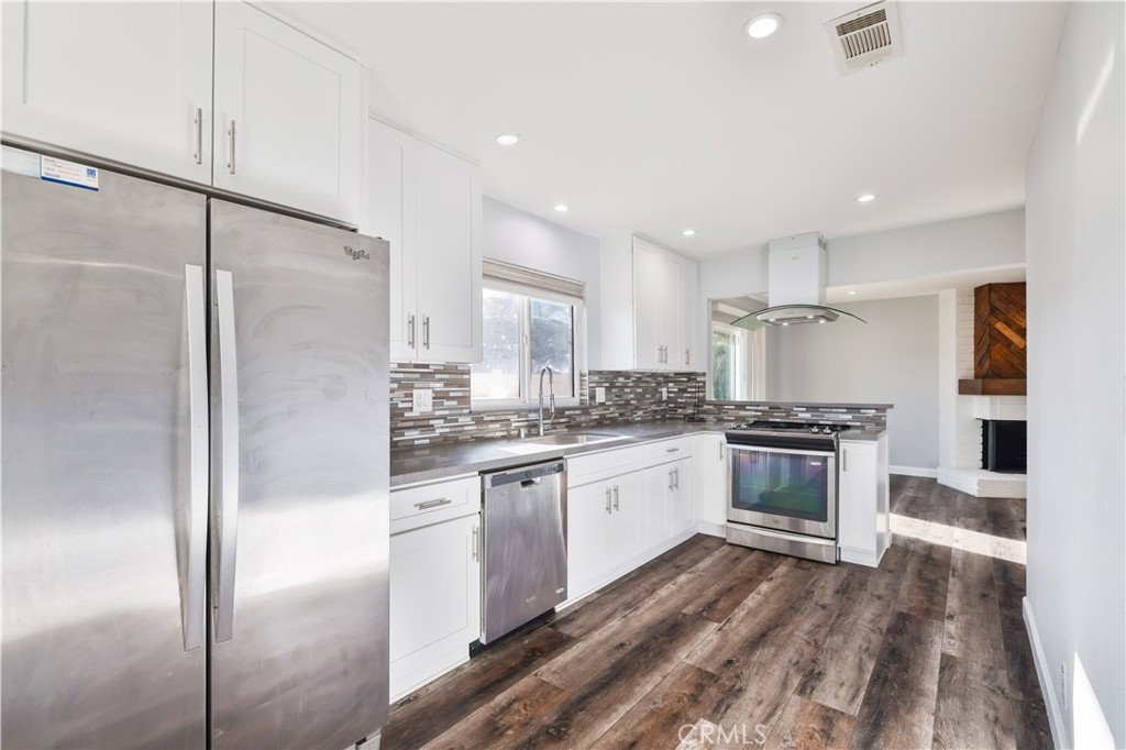2702 College Lane La Verne, CA 91750 - Photo 3 of 53 a kitchen with stainless steel appliances granite countertop a refrigerator and a stove top oven