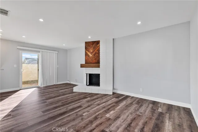 a view of an empty room and wooden floor