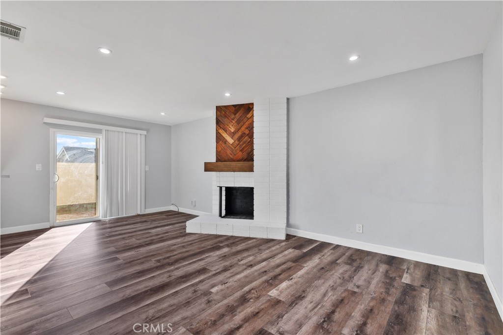 2702 College Lane La Verne, CA 91750 - Photo 31 of 53 a view of empty room with wooden floor and fireplace