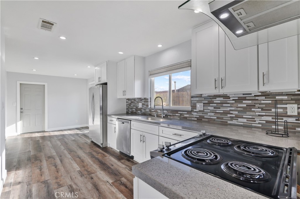 2702 College Lane La Verne, CA 91750 - Photo 4 of 53 a kitchen with a stove a sink and a refrigerator