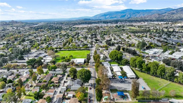 an aerial view of residential houses with outdoor space and city view