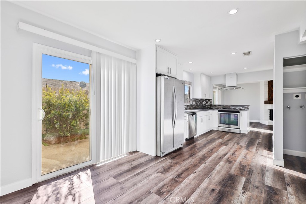2702 College Lane La Verne, CA 91750 - Photo 6 of 53 a view of a kitchen with refrigerator and wooden floor