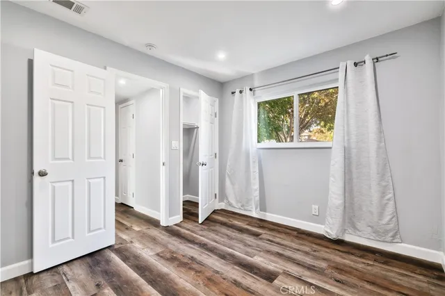 a view of a room with wooden floor and closet