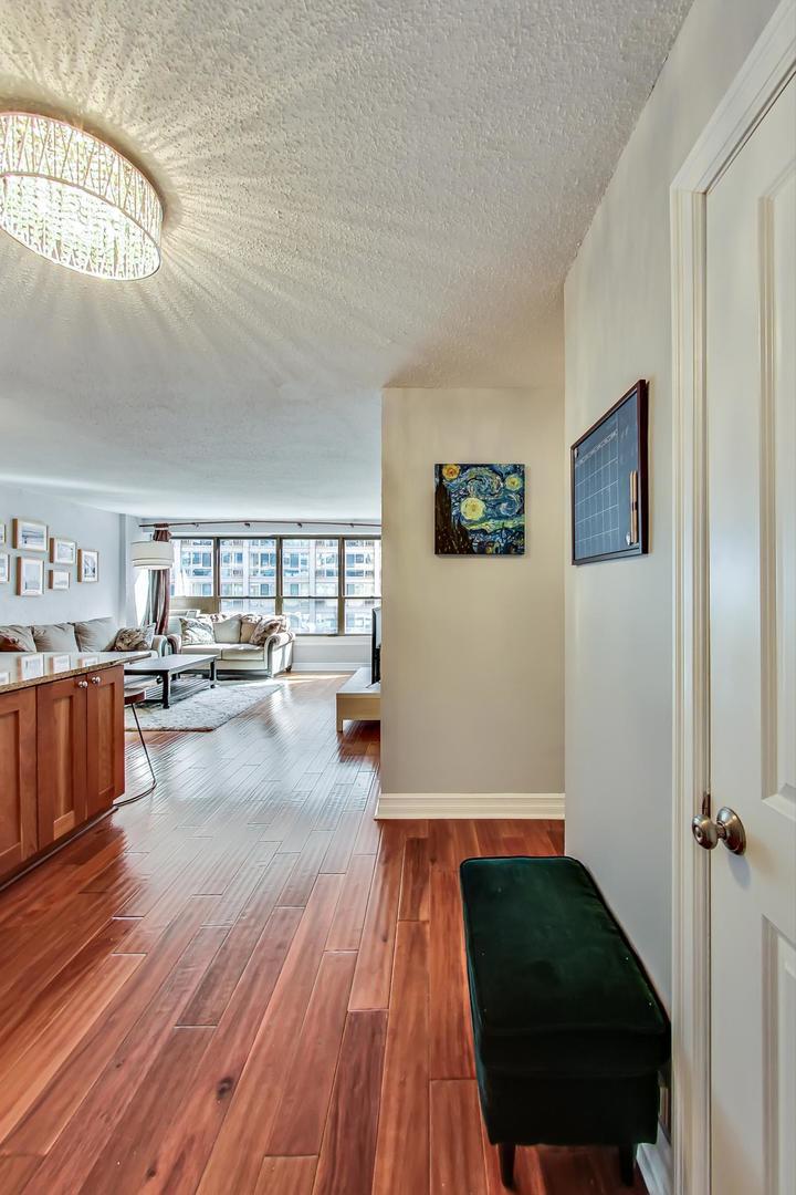2930 North Sheridan Road, Unit 811 Chicago, IL 60657 - Photo 18 of 52 a living room with furniture and a wooden floor