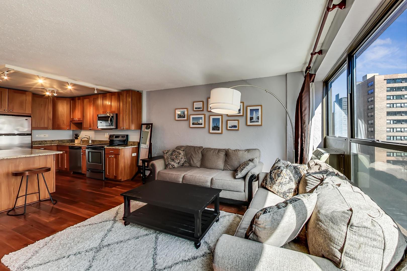 2930 North Sheridan Road, Unit 811 Chicago, IL 60657 - Photo 22 of 52 a living room with furniture kitchen and a wooden floor