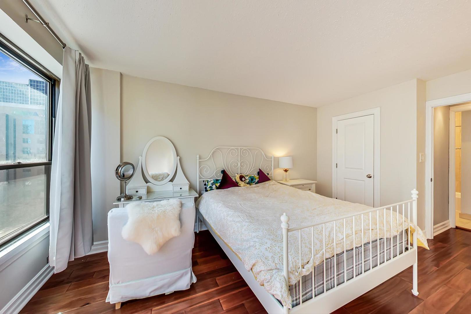 2930 North Sheridan Road, Unit 811 Chicago, IL 60657 - Photo 28 of 52 a bedroom with a bed and window