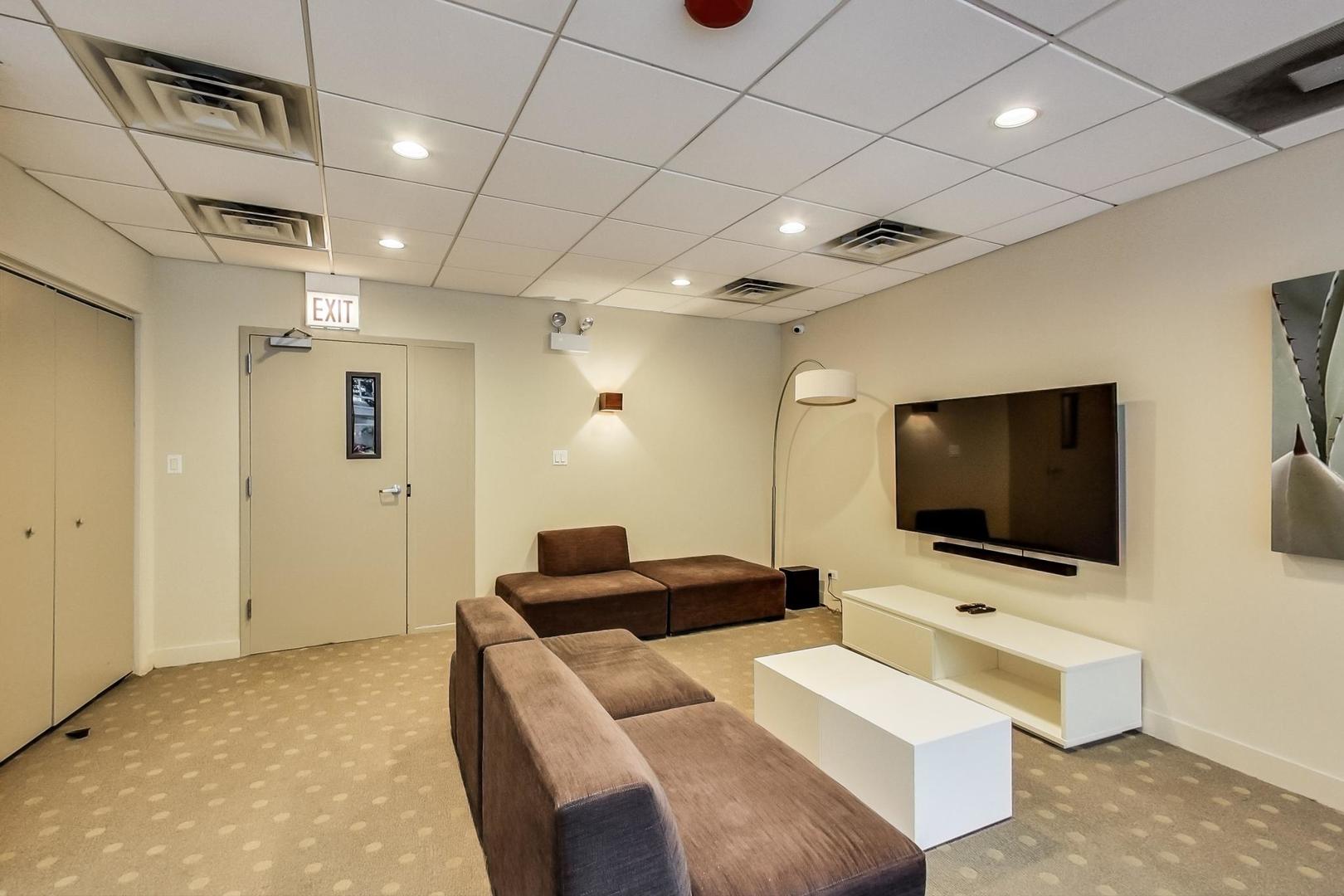 2930 North Sheridan Road, Unit 811 Chicago, IL 60657 - Photo 48 of 52 a living room with furniture and a flat screen tv