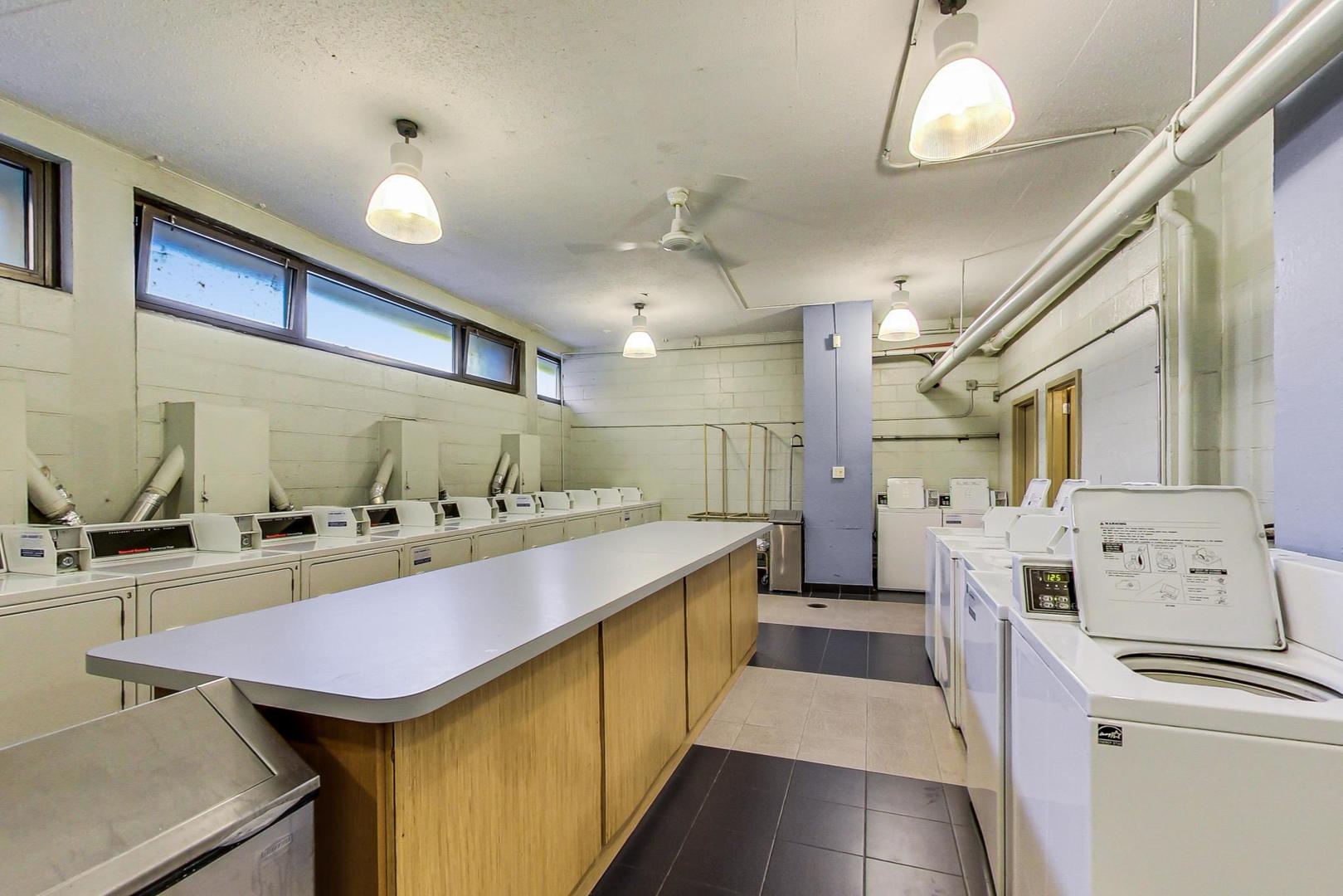 2930 North Sheridan Road, Unit 811 Chicago, IL 60657 - Photo 50 of 52 a kitchen with stainless steel appliances granite countertop a sink and cabinets