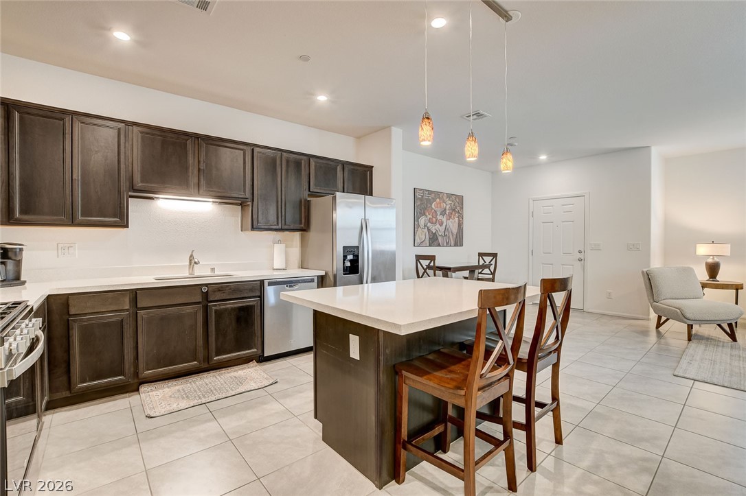 484 Filaree Place Henderson, NV 89015 - Photo 20 of 71 This modern kitchen features a spacious island, sleek countertops, and contemporary appliances for everyday living.
