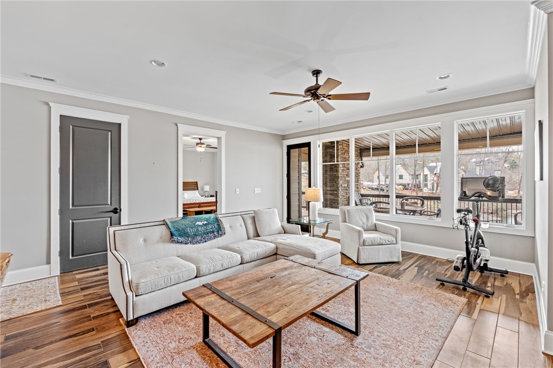 827 Top Ridge Drive Sunset, SC 29685 - Photo 25 of 44 This living room provides a comfortable space for relaxation and entertaining, with views of the outdoors and access to covered porch.