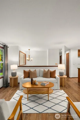 a living room with furniture a lamp and a table