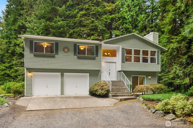 a front view of a house with a garden
