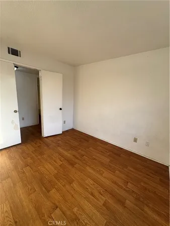 an empty room with wooden floor
