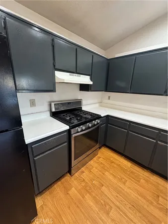 a kitchen with a stove and a refrigerator