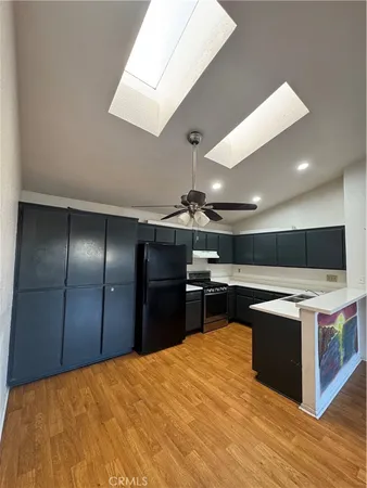 a kitchen with a stove and a refrigerator