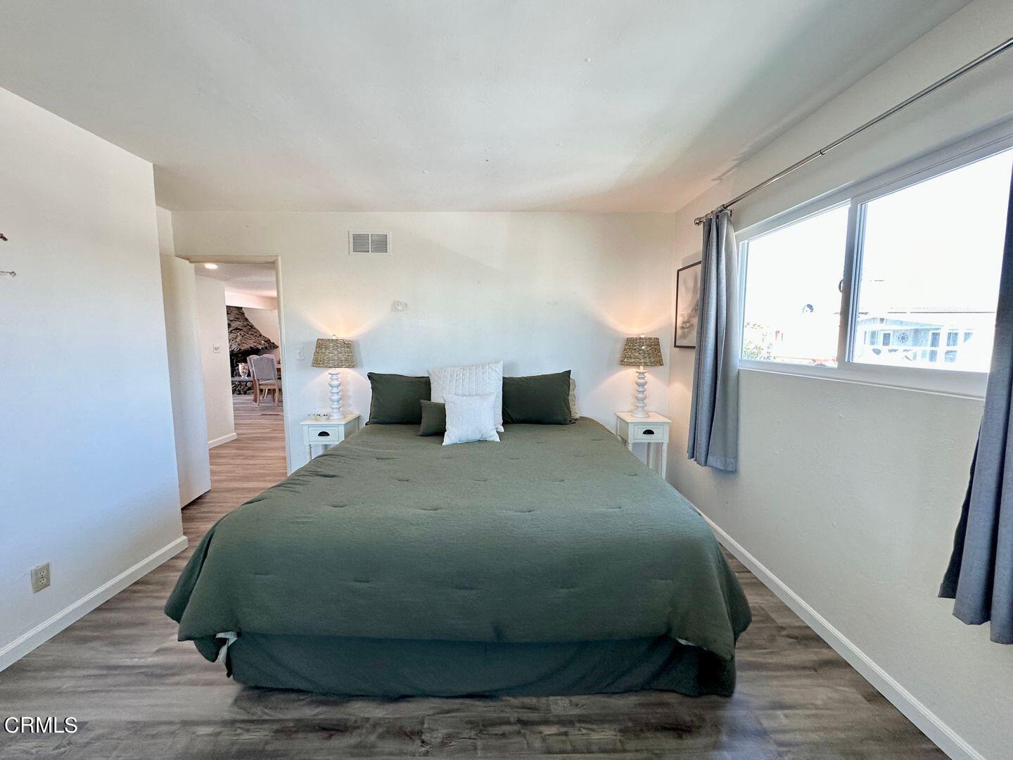 2201 Ocean Drive Oxnard, CA 93035 - Photo 19 of 30 a bedroom with a bed and wooden floor