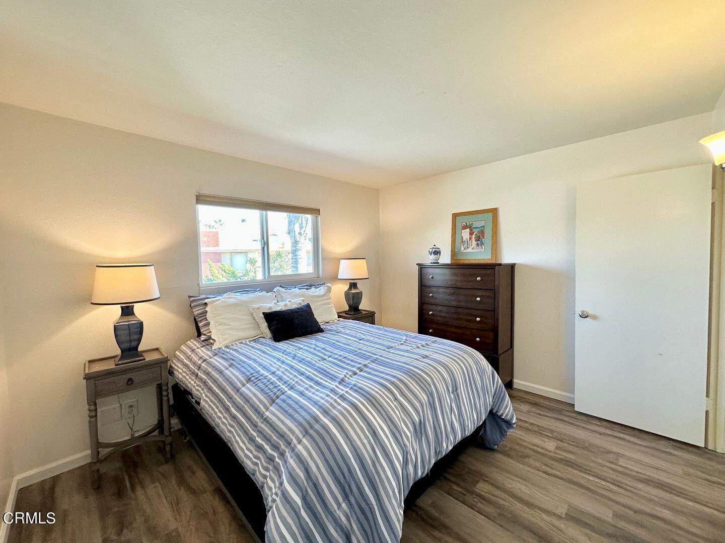 2201 Ocean Drive Oxnard, CA 93035 - Photo 20 of 30 a bedroom with a bed and wooden floor