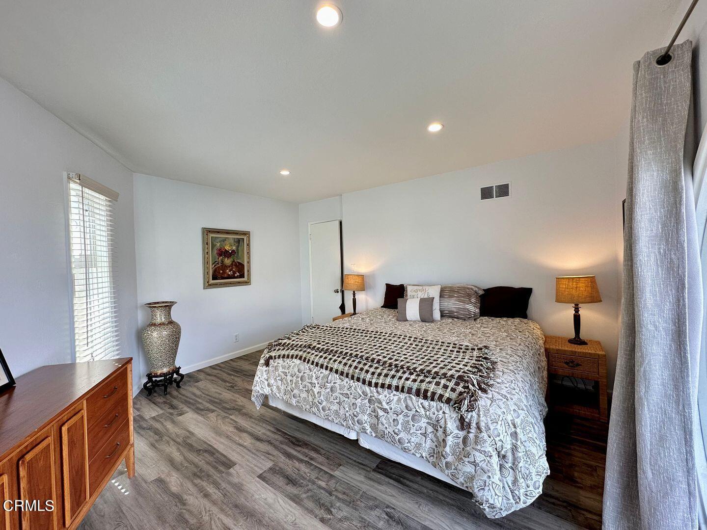 2201 Ocean Drive Oxnard, CA 93035 - Photo 23 of 30 a bedroom with a bed and wooden floor