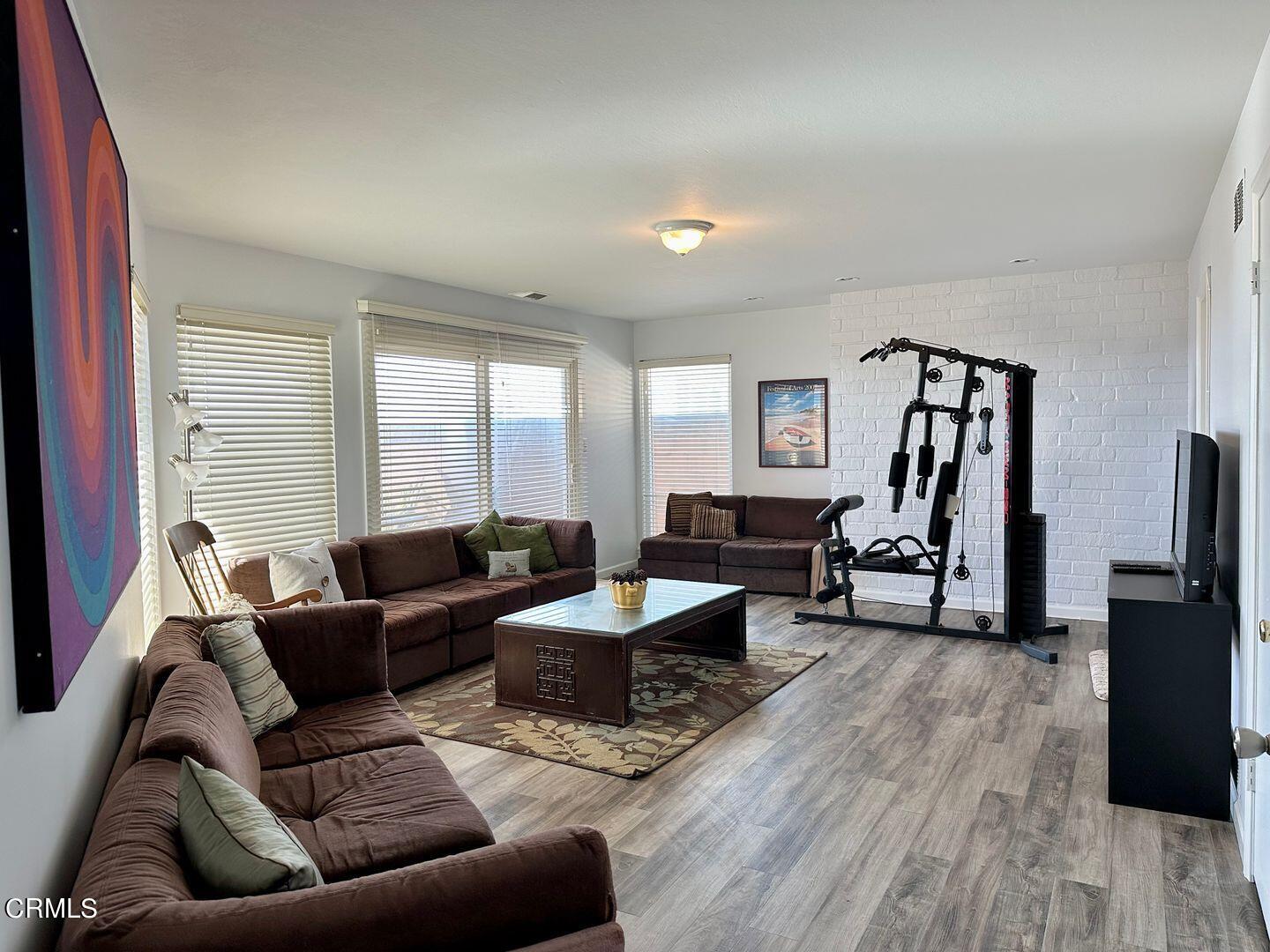 2201 Ocean Drive Oxnard, CA 93035 - Photo 24 of 30 a living room with furniture and a flat screen tv