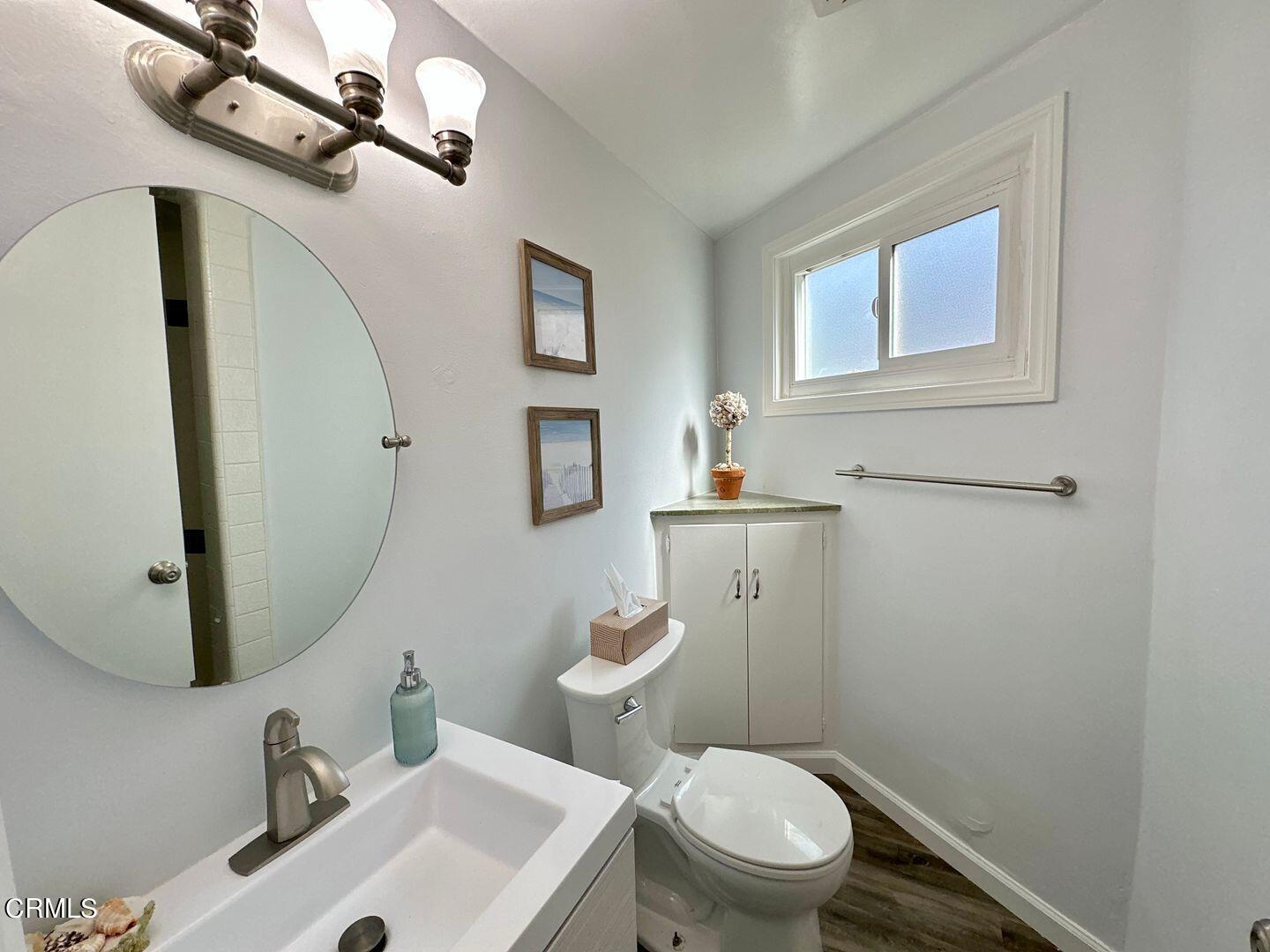 2201 Ocean Drive Oxnard, CA 93035 - Photo 26 of 30 a bathroom with a sink a mirror and a toilet