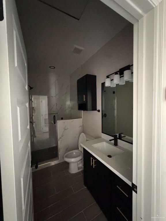 Lot 23 Farrell Road, Unit 1 Weslaco, TX 78596 - Photo 3 of 9 a bathroom with a sink a toilet and shower