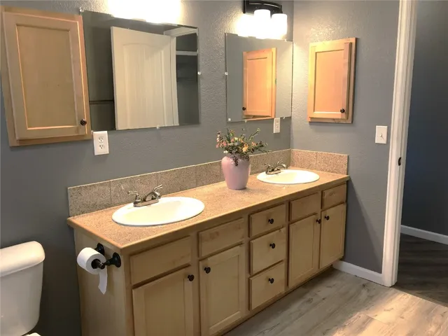a bathroom with a double vanity sink and a mirror