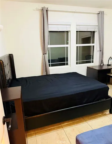 a living room with a bed furniture and a window