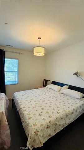 a bed sitting in a bedroom next to a window