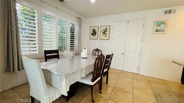 a view of a dining room with furniture and a large window