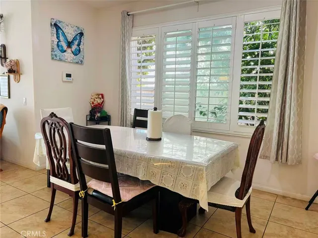 a view of a dining room with a table and chairs