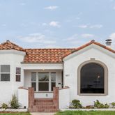 a view of a white house with large windows