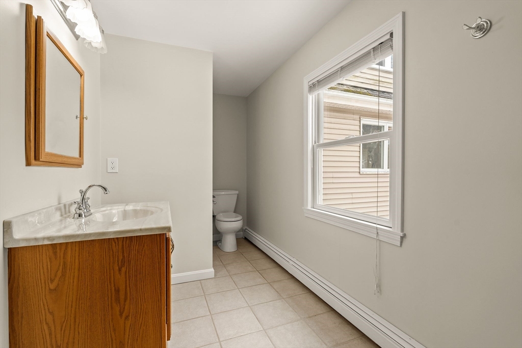 630 Pleasant Street Canton, MA 02021 - Photo 20 of 31 a bathroom with a sink and a mirror