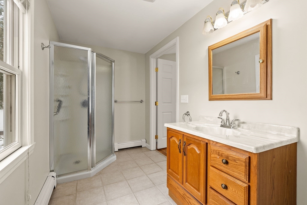 630 Pleasant Street Canton, MA 02021 - Photo 21 of 31 a bathroom with a sink vanity and mirror