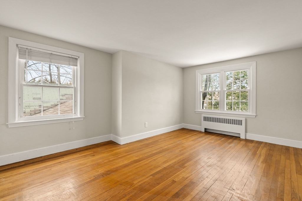 630 Pleasant Street Canton, MA 02021 - Photo 25 of 31 a view of an empty room with wooden floor and a window