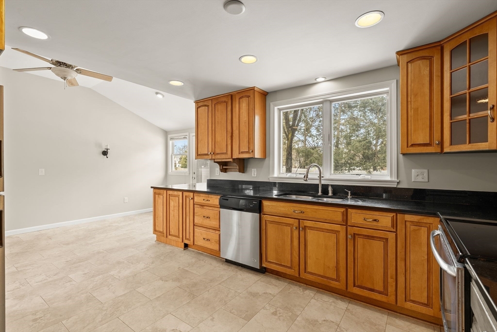 630 Pleasant Street Canton, MA 02021 - Photo 6 of 31 a kitchen with granite countertop a stove sink and microwave