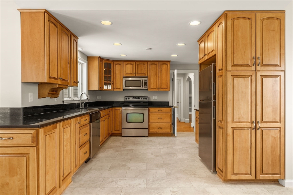 630 Pleasant Street Canton, MA 02021 - Photo 7 of 31 a kitchen with stainless steel appliances granite countertop a refrigerator and a sink
