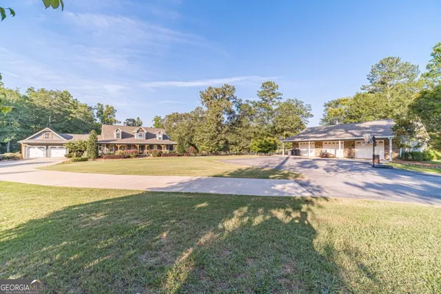 a view of a swimming pool with a patio and a yard
